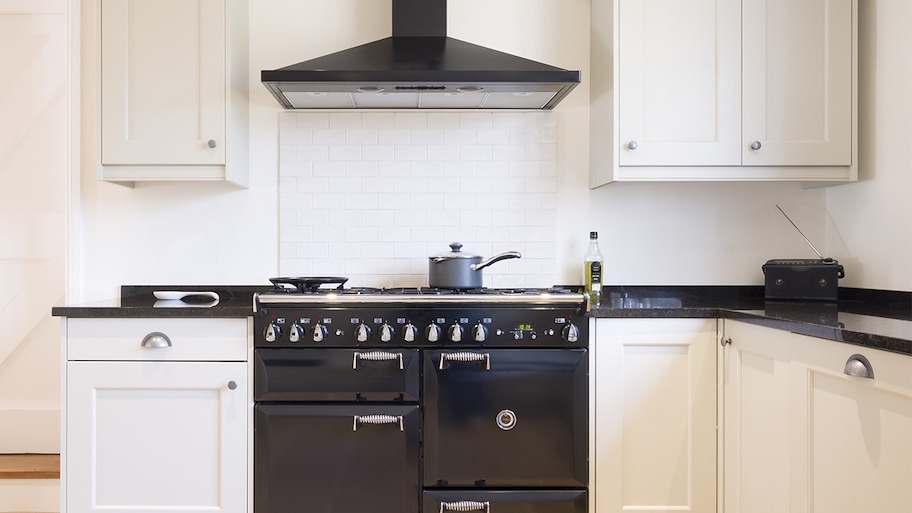 Black oven range with black vent hood